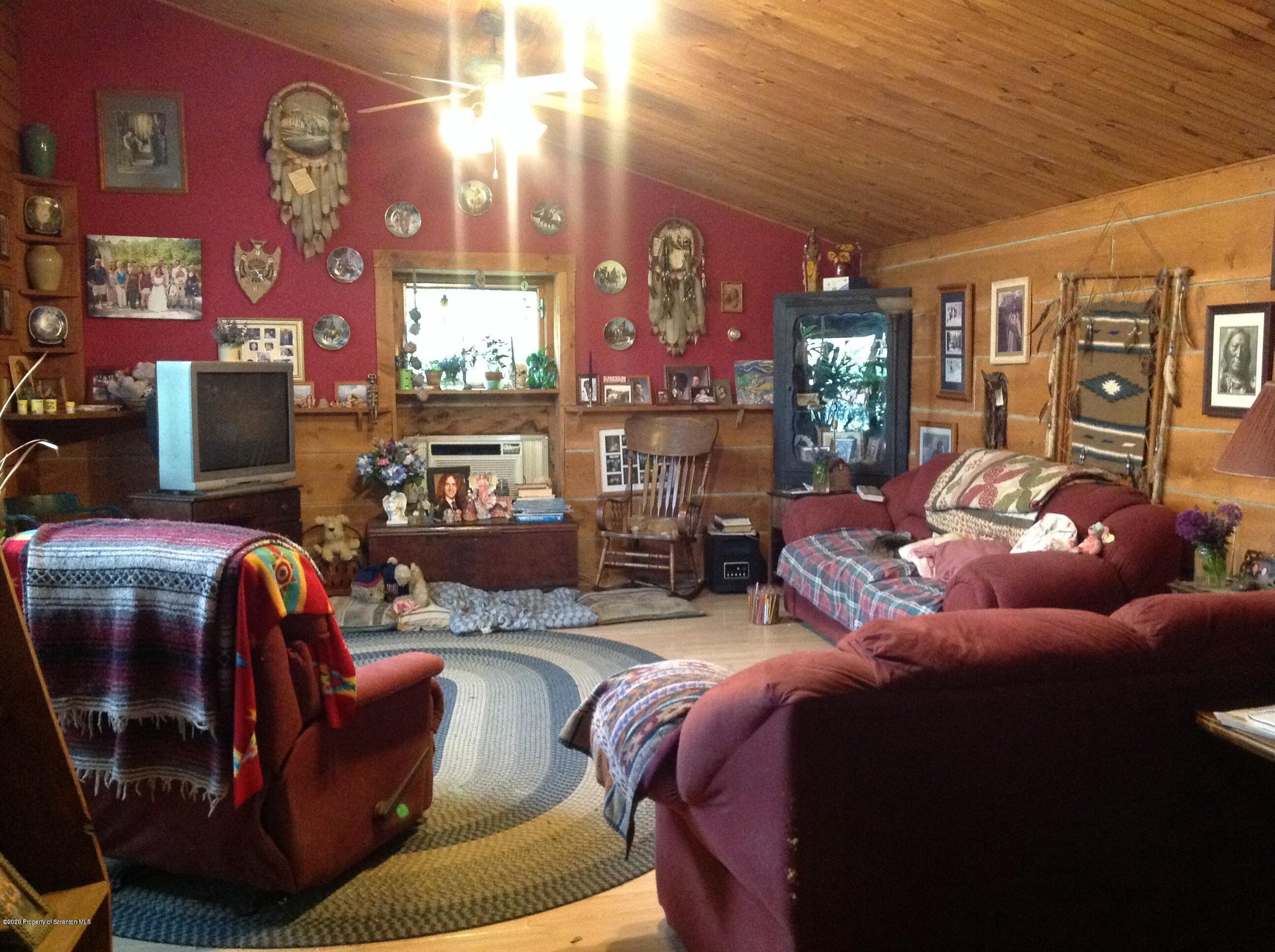 875 Marshall Squier Road Nicholson, PA 18446 - Photo 9 of 29 a living room with furniture fireplace and flat screen tv