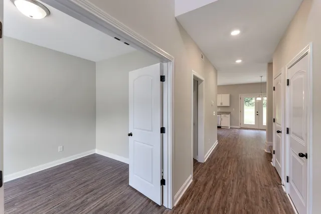 a view of a hallway with wooden floor