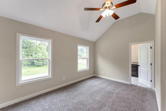a view of empty room with windows and fan