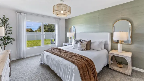 a bed room with a bed and a chair