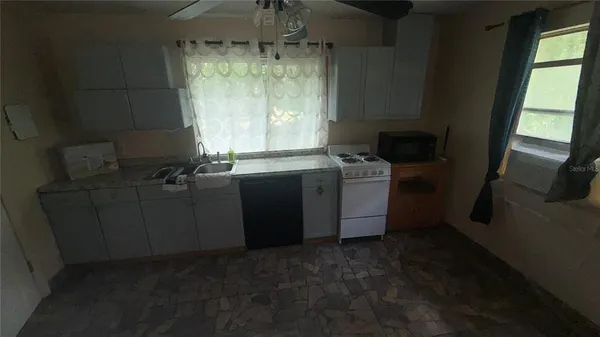 a view of a livingroom with furniture and an empty space
