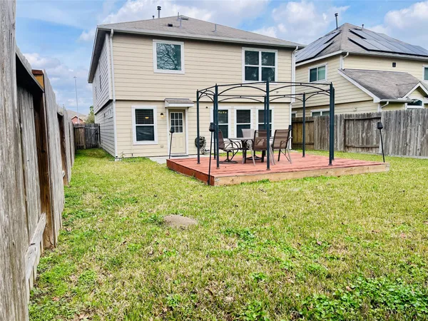 a view of a house with a yard and sitting area