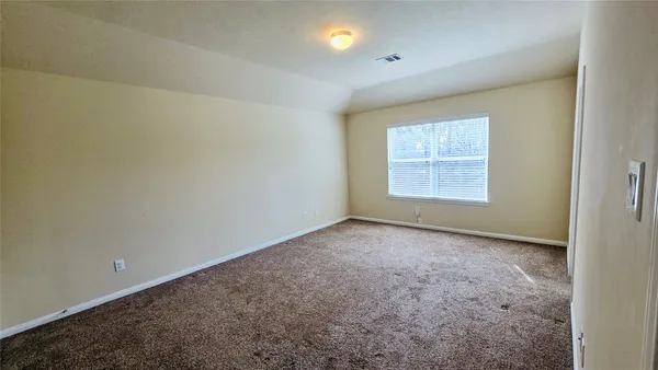 an empty room with a empty space and windows