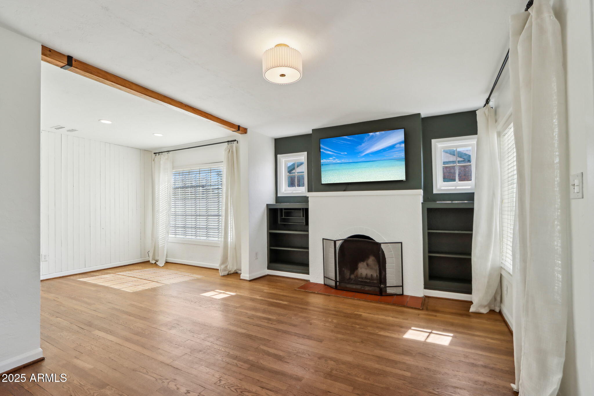 2237 North 9th Street Phoenix, AZ 85006 - Photo 5 of 29 a view of an empty room with a fireplace and a window