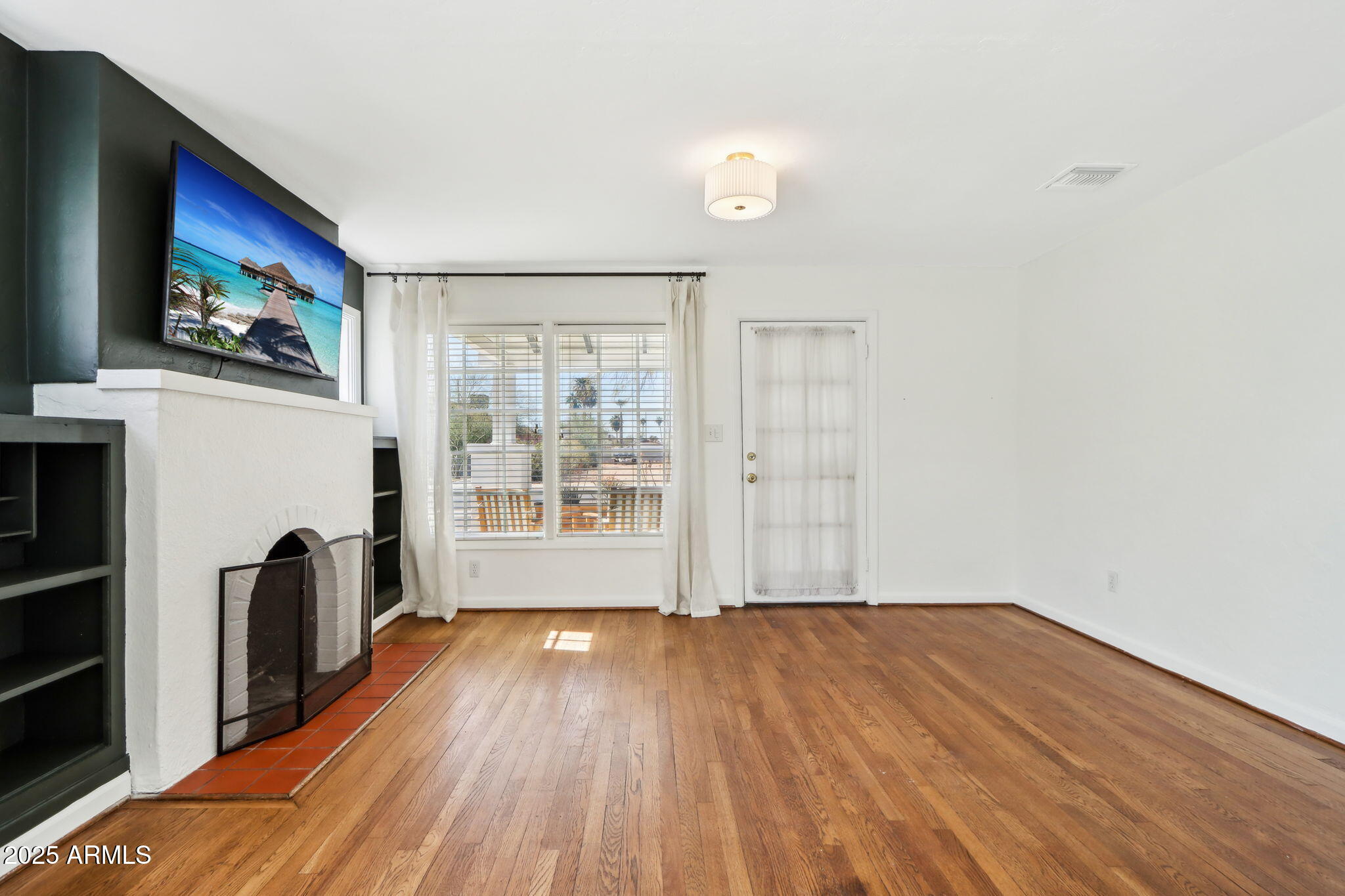 2237 North 9th Street Phoenix, AZ 85006 - Photo 7 of 29 a view of empty room with wooden floor and fan