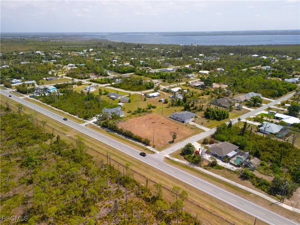 an aerial view of residential houses with outdoor space and swimming pool