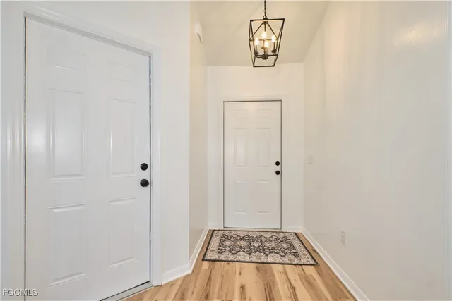 a view of a room with a door and wooden floor