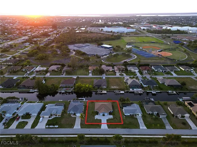 an aerial view of residential houses with outdoor space and swimming pool