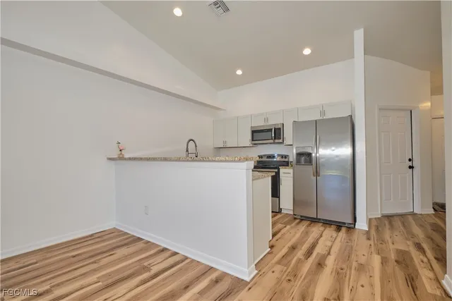a view of kitchen with wooden floor