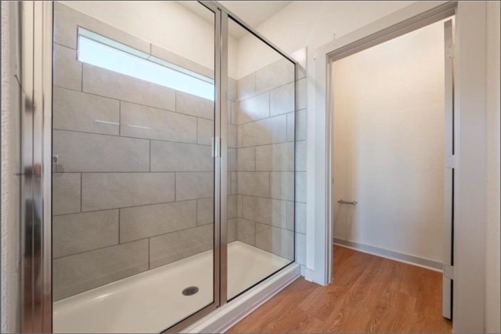 10805 Meris Lane Austin, TX 78754 - Photo 20 of 28 A well-appointed shower stall features modern tile work and a convenient transom window.