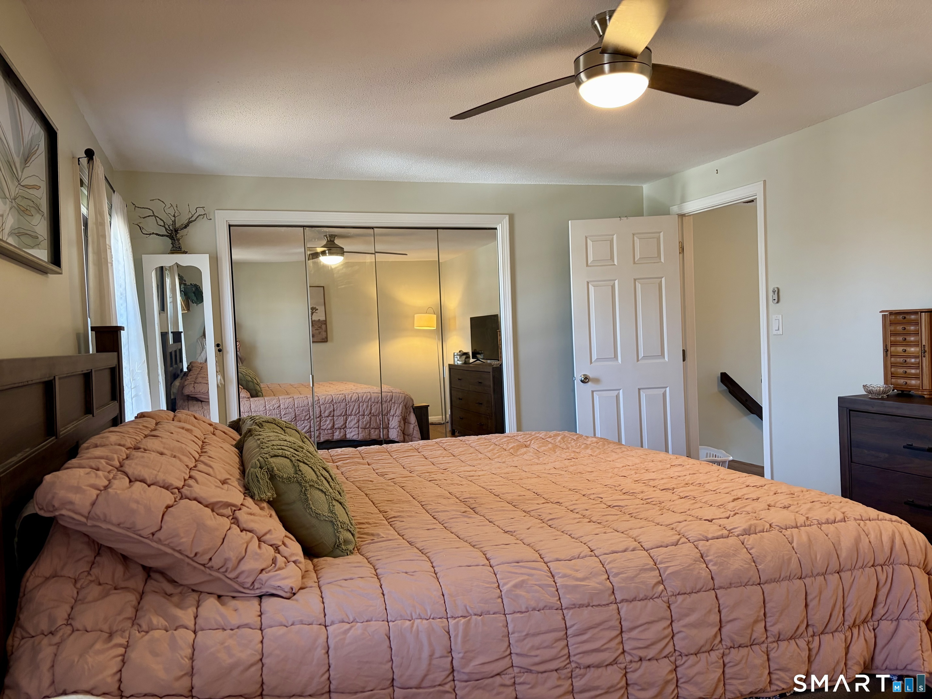216 Natchaug Drive, Unit 216 Meriden, CT 06450 - Photo 20 of 40 a bedroom with a bed and a chandelier