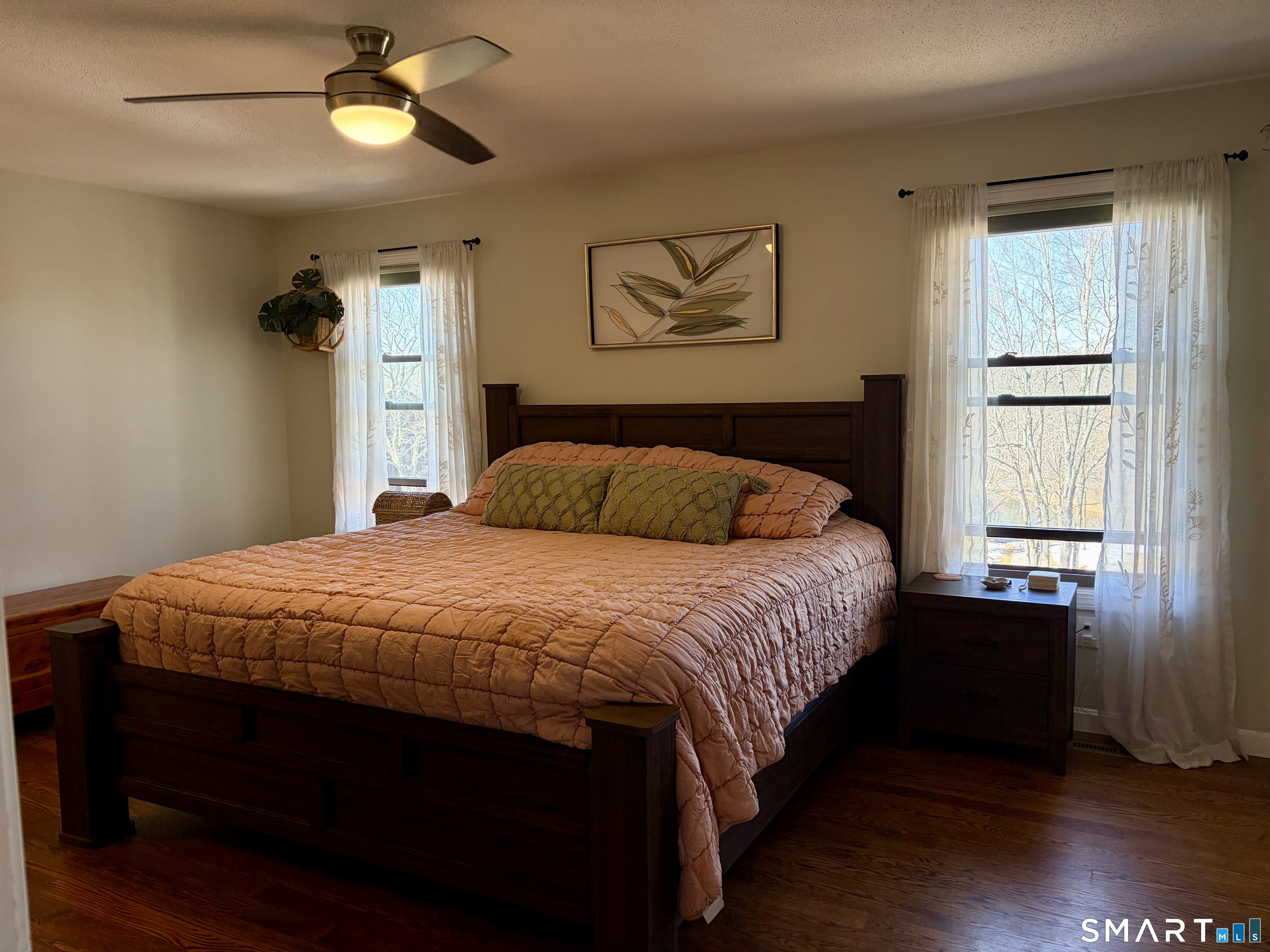 216 Natchaug Drive, Unit 216 Meriden, CT 06450 - Photo 21 of 40 a bedroom with a bed and wooden floor