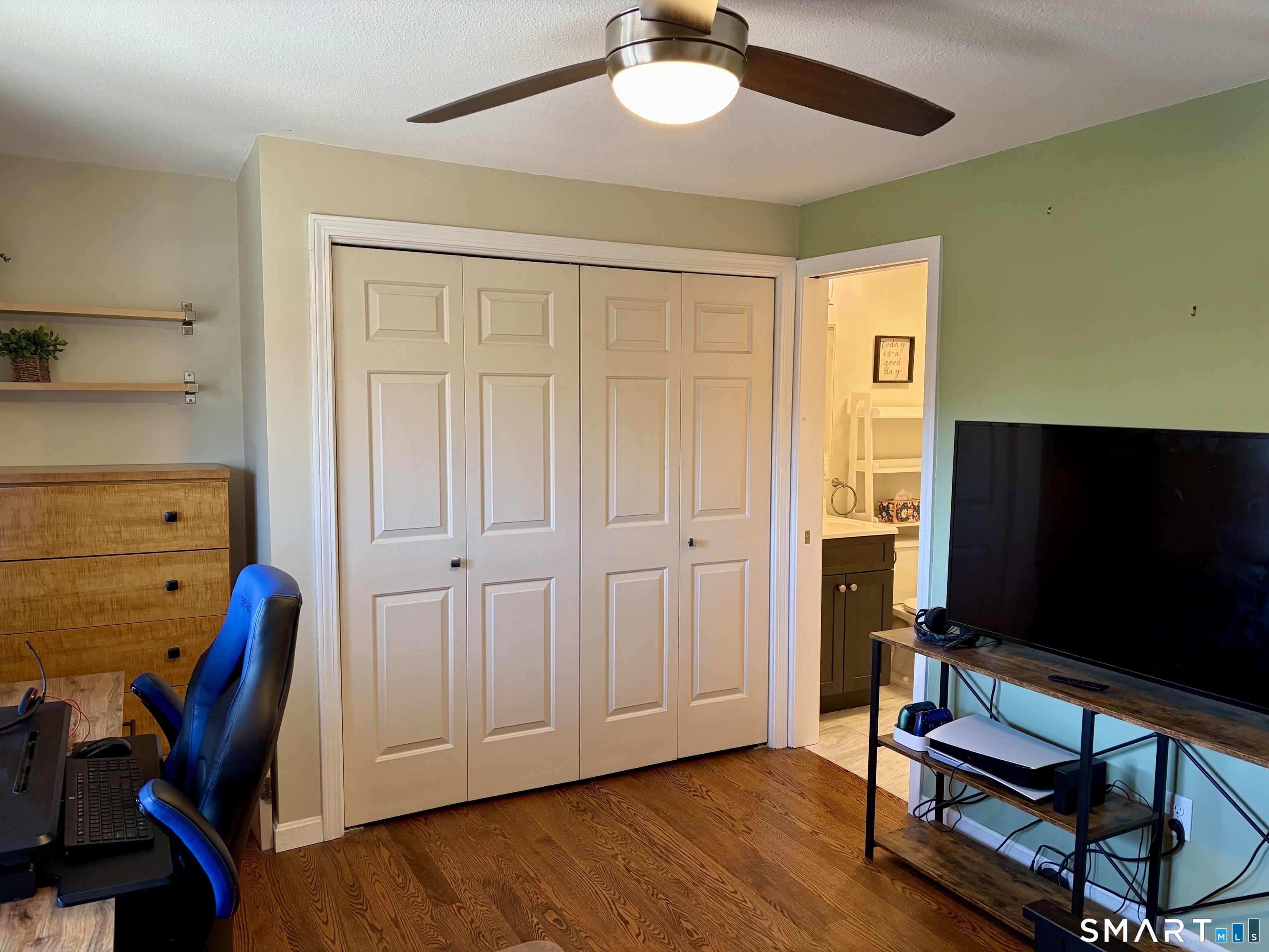 216 Natchaug Drive, Unit 216 Meriden, CT 06450 - Photo 25 of 40 a living room with furniture and a flat screen tv