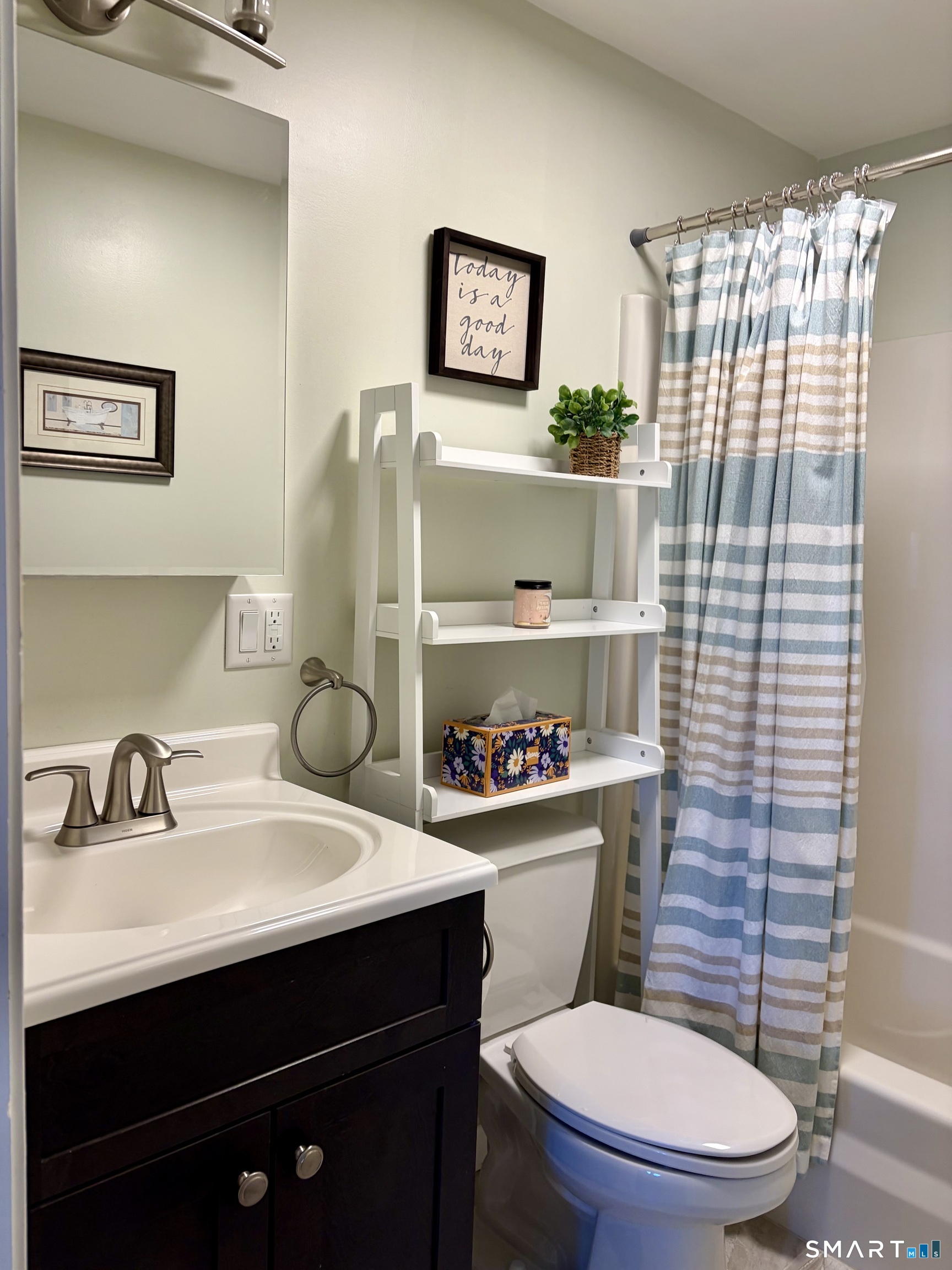 216 Natchaug Drive, Unit 216 Meriden, CT 06450 - Photo 28 of 40 a bathroom with a sink a toilet and shower curtain