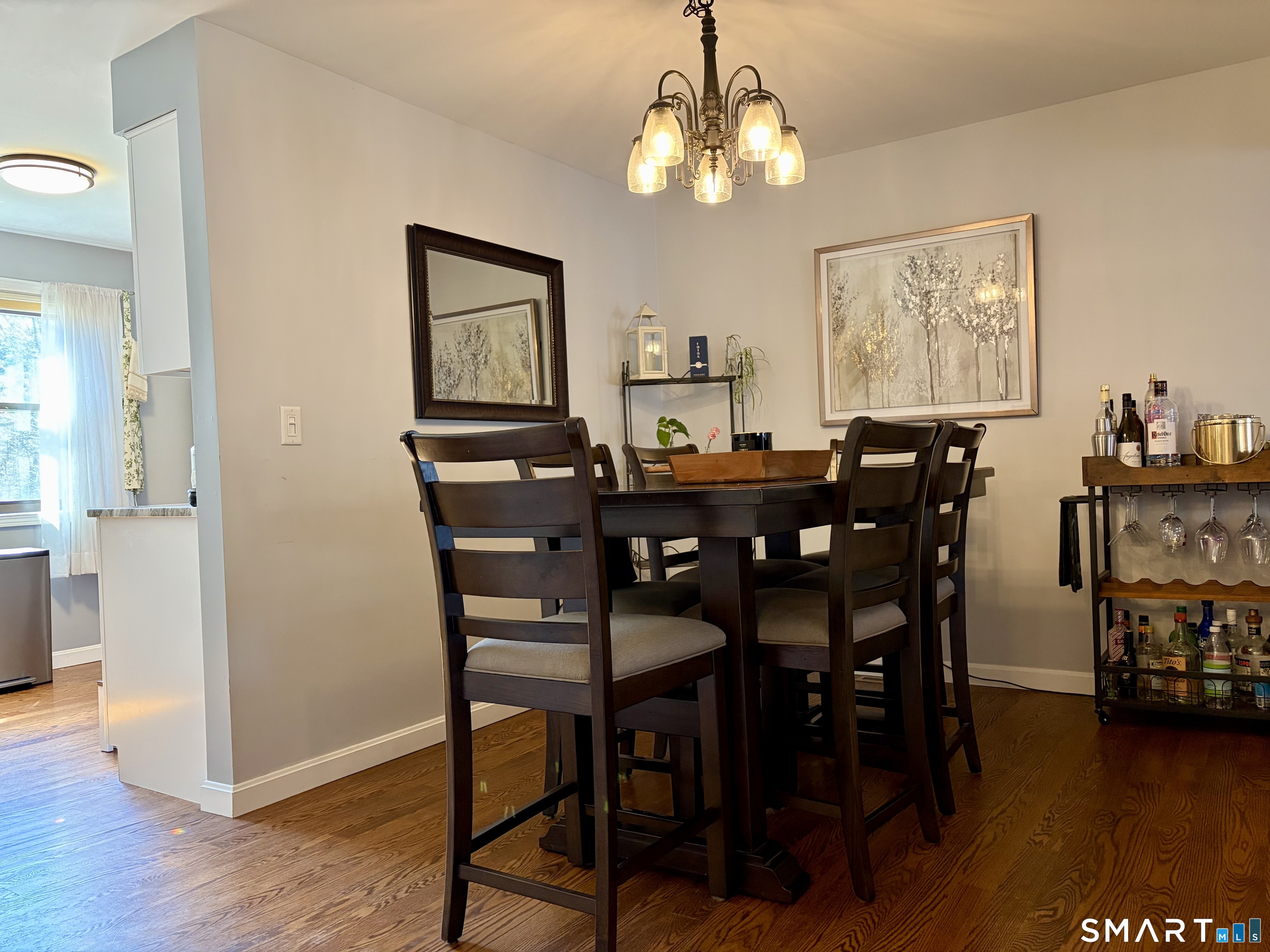 216 Natchaug Drive, Unit 216 Meriden, CT 06450 - Photo 7 of 40 a view of a dining room with furniture wooden floor and chandelier