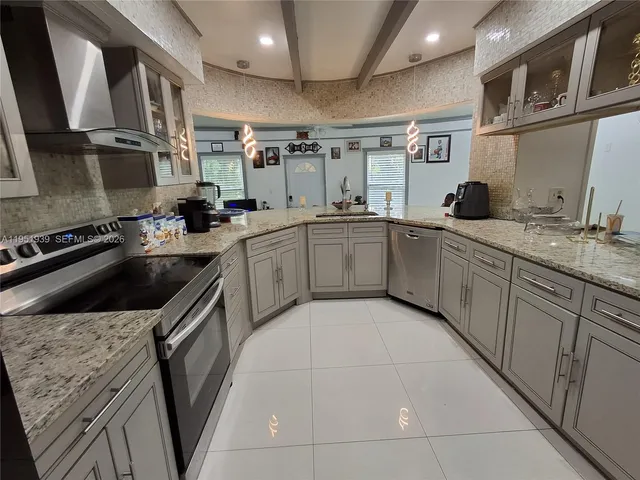 a kitchen with a sink a stove and cabinets