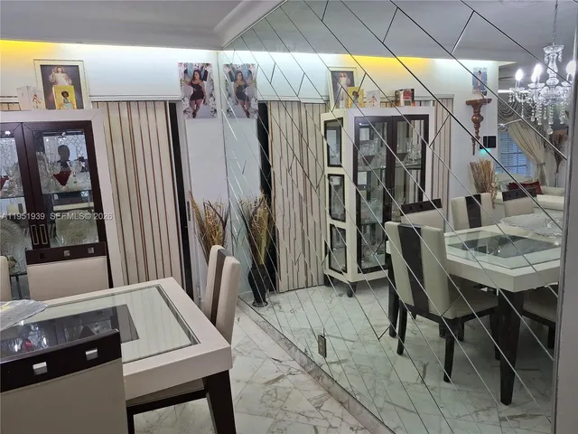 a view of a dining room with furniture and chandelier