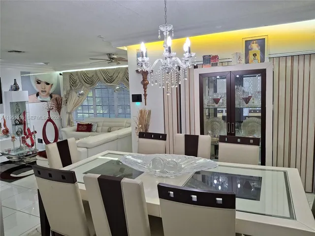 a kitchen with stainless steel appliances kitchen island granite countertop a table and chairs in it