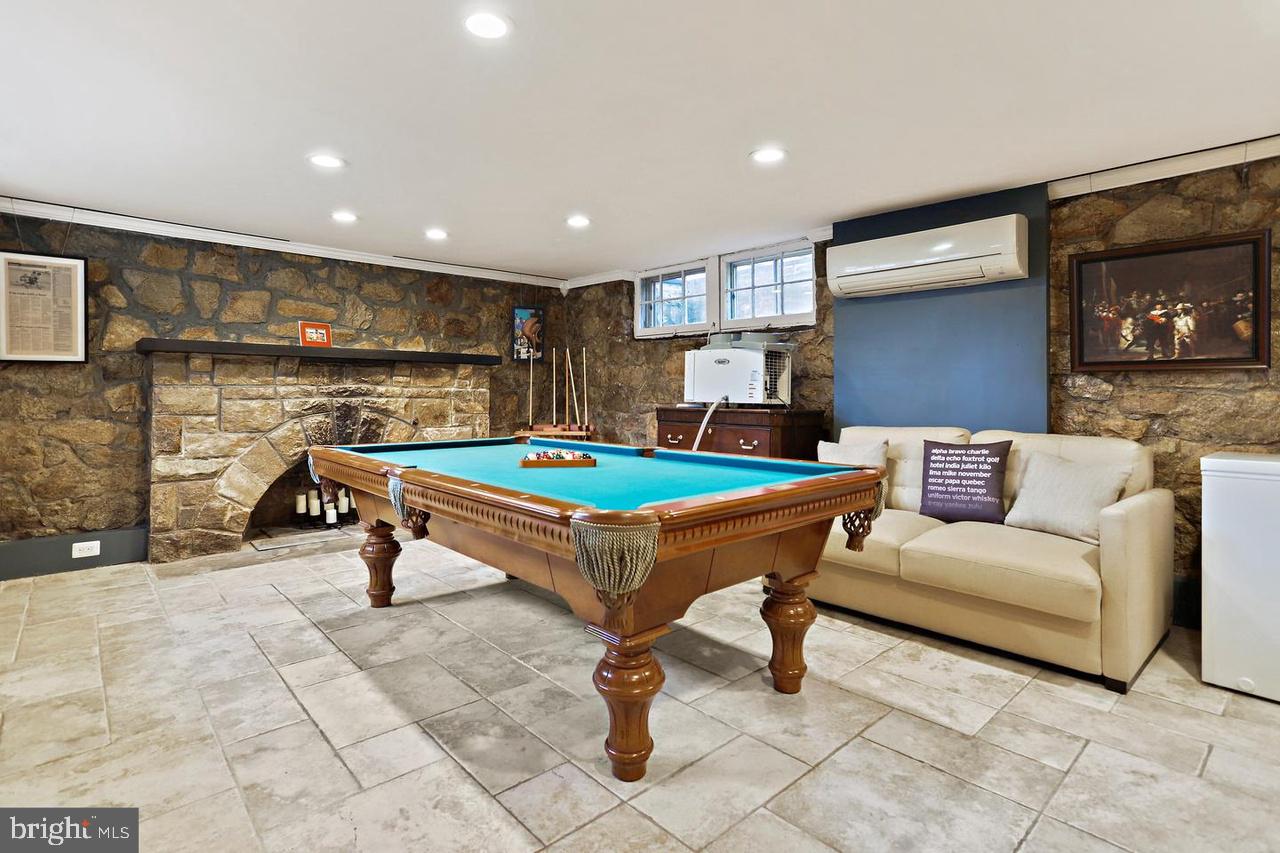 2347 South Arlington Ridge Road Arlington, VA 22202 - Photo 22 of 42 Cozy game room with stone accents.