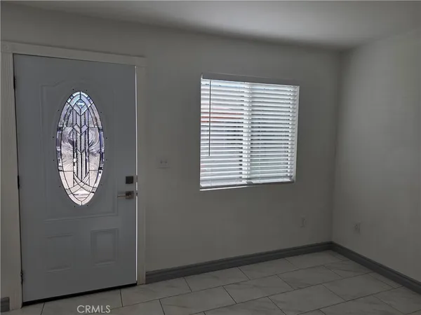 a view of a livingroom with an empty space and a window