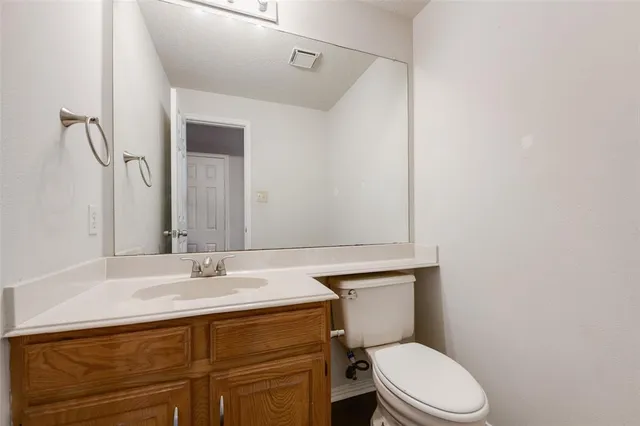a bathroom with a sink a toilet and mirror