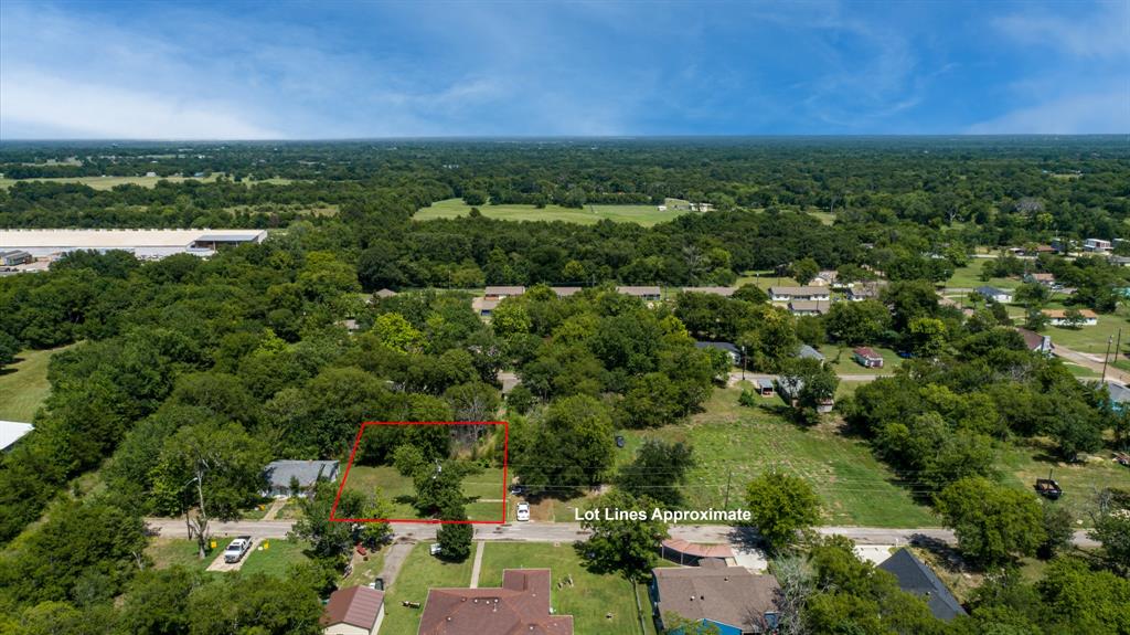 119 Norris Street Commerce, TX 75428 - Photo 2 of 9 an aerial view of residential houses with outdoor space and trees