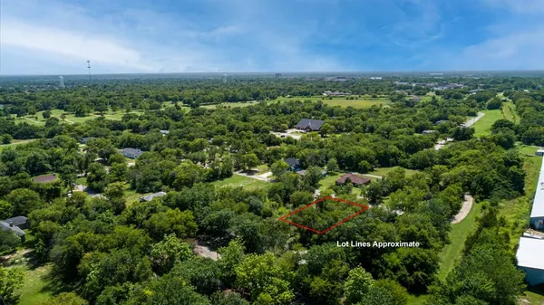 an aerial view of a houses with a yard