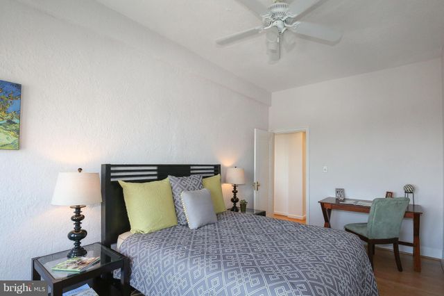 a bedroom with a bed and a chair