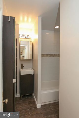 a bathroom with a shower and a sink