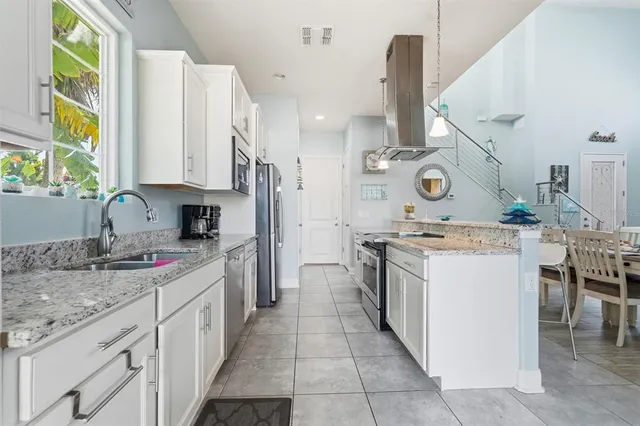 a kitchen with a stove and a wooden floor