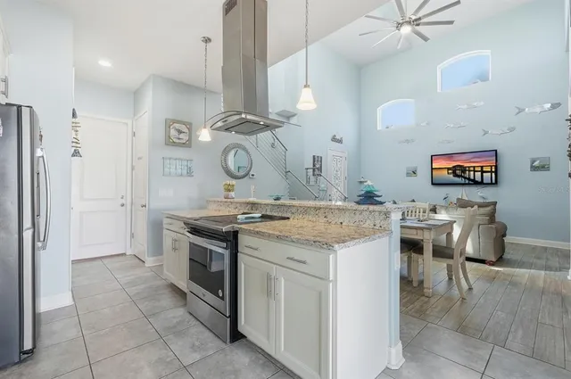 a kitchen with cabinets and chairs