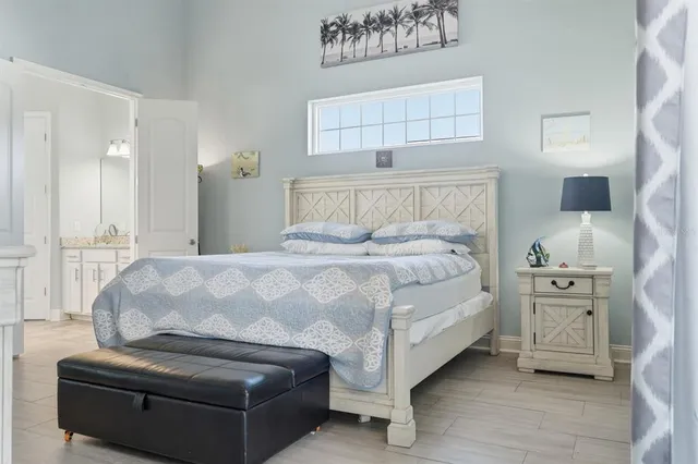 a spacious bedroom with a bed and a couch