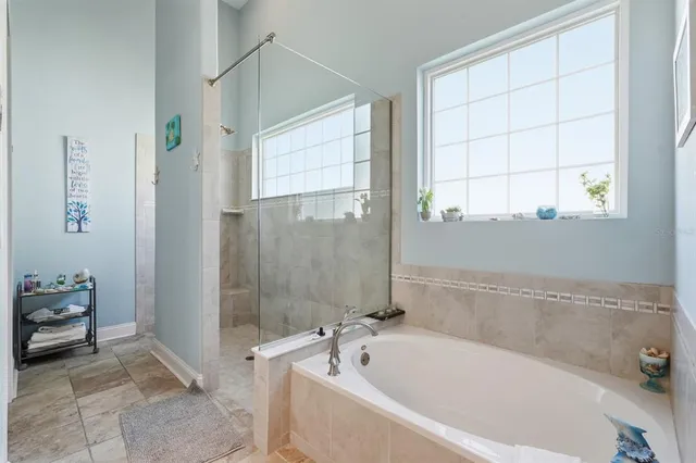 a view of a room with a ceiling fan and wooden floor