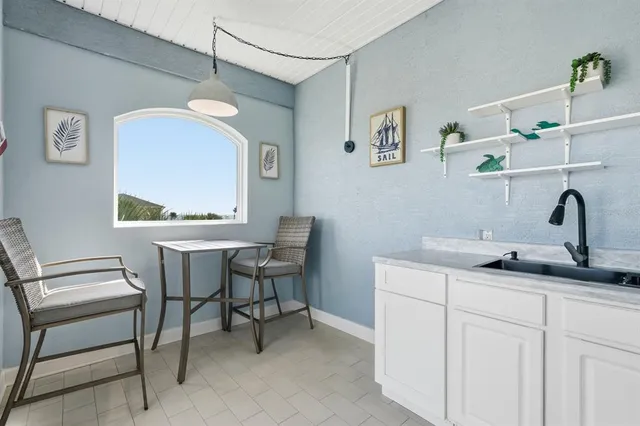 a room with a sink and a mirror