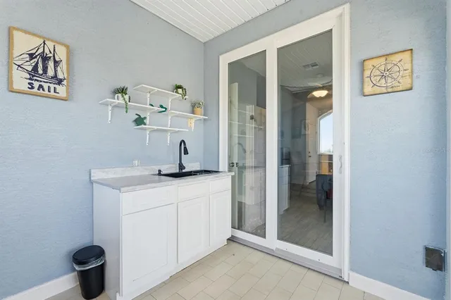 a spacious bedroom with a bed couch and a window