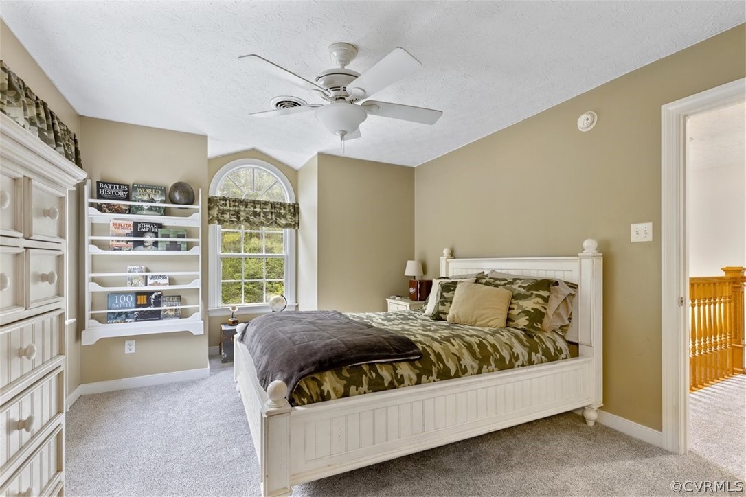 3521 Wakema Road West Point, VA 23181 - Photo 28 of 49 a bedroom with a large bed and a chandelier