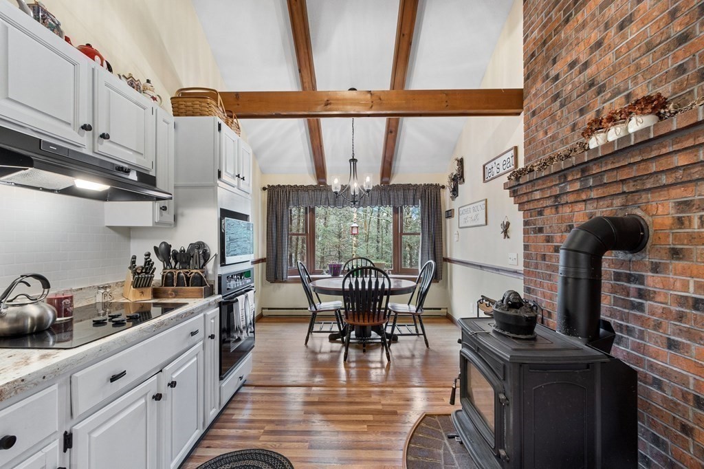 911 Conant Road Athol, MA 01331 - Photo 14 of 34 a kitchen with stainless steel appliances granite countertop a stove a sink and a refrigerator