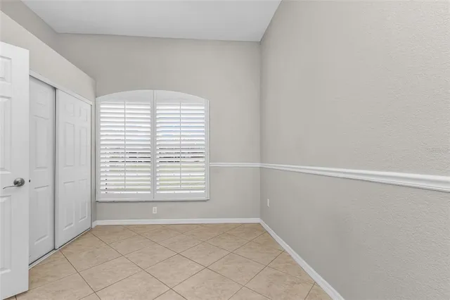a bathroom with a granite countertop sink toilet a large mirror and a window