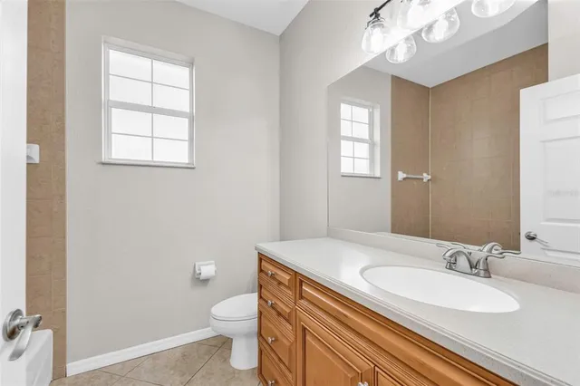 a view of a trees with yard in front of the house