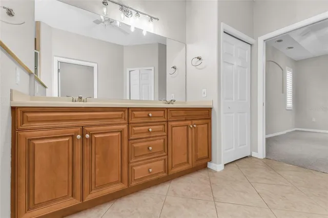 a bathroom with a double vanity sink and a mirror