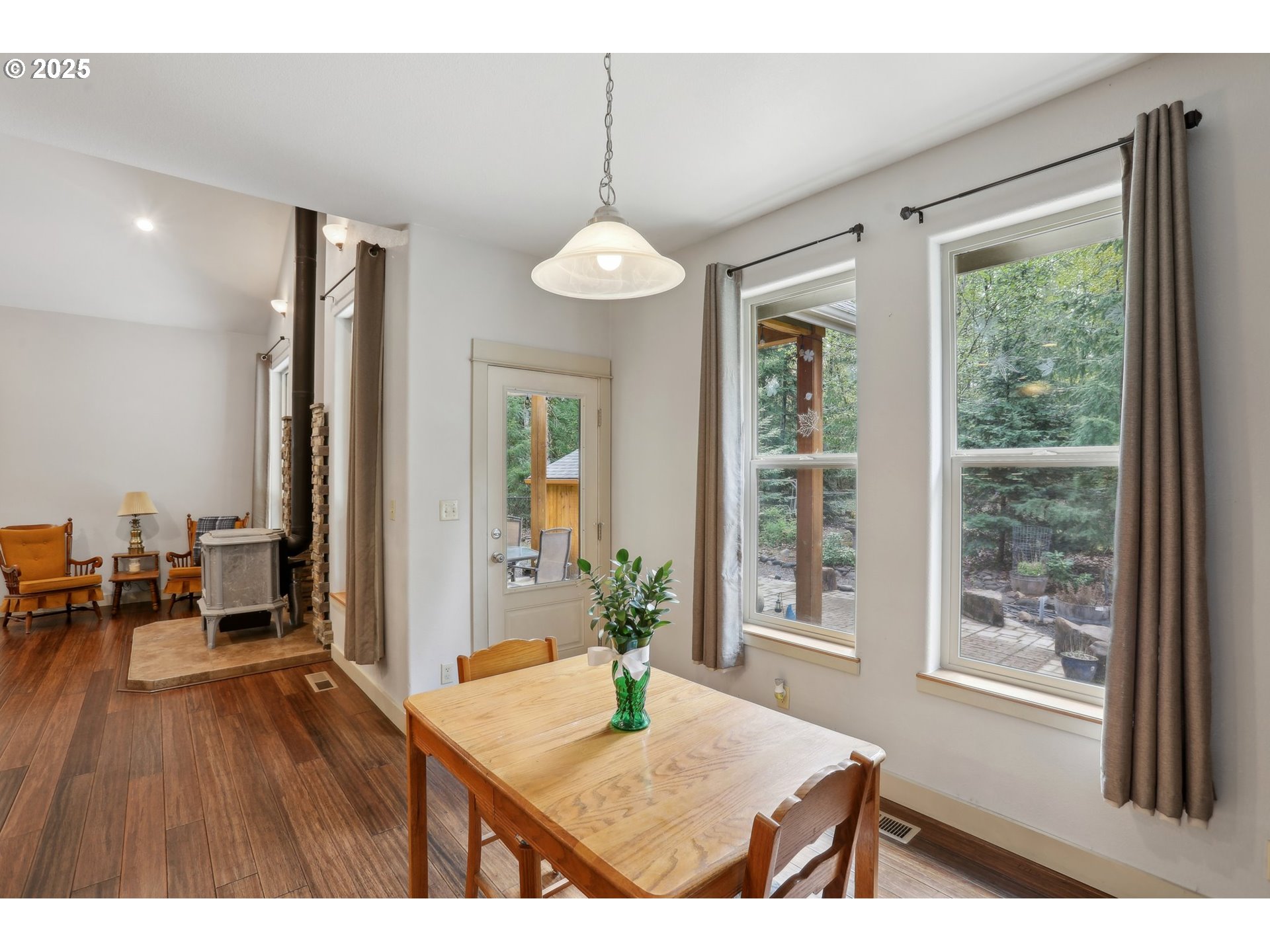 230 Riley Court Toutle, WA 98649 - Photo 14 of 48 a dining room with wooden floor a chandelier a wooden table and chairs