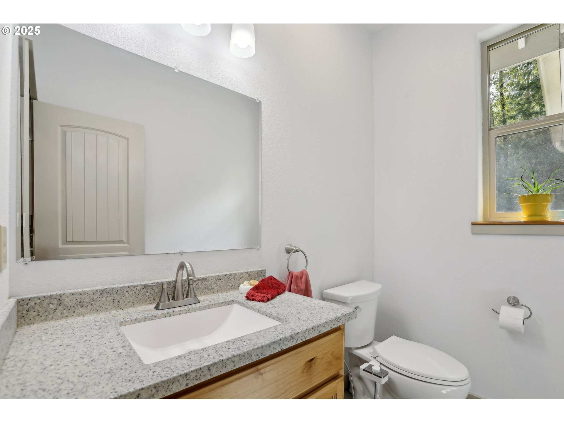 230 Riley Court Toutle, WA 98649 - Photo 32 of 48 a bathroom with a granite countertop sink mirror vanity and toilet