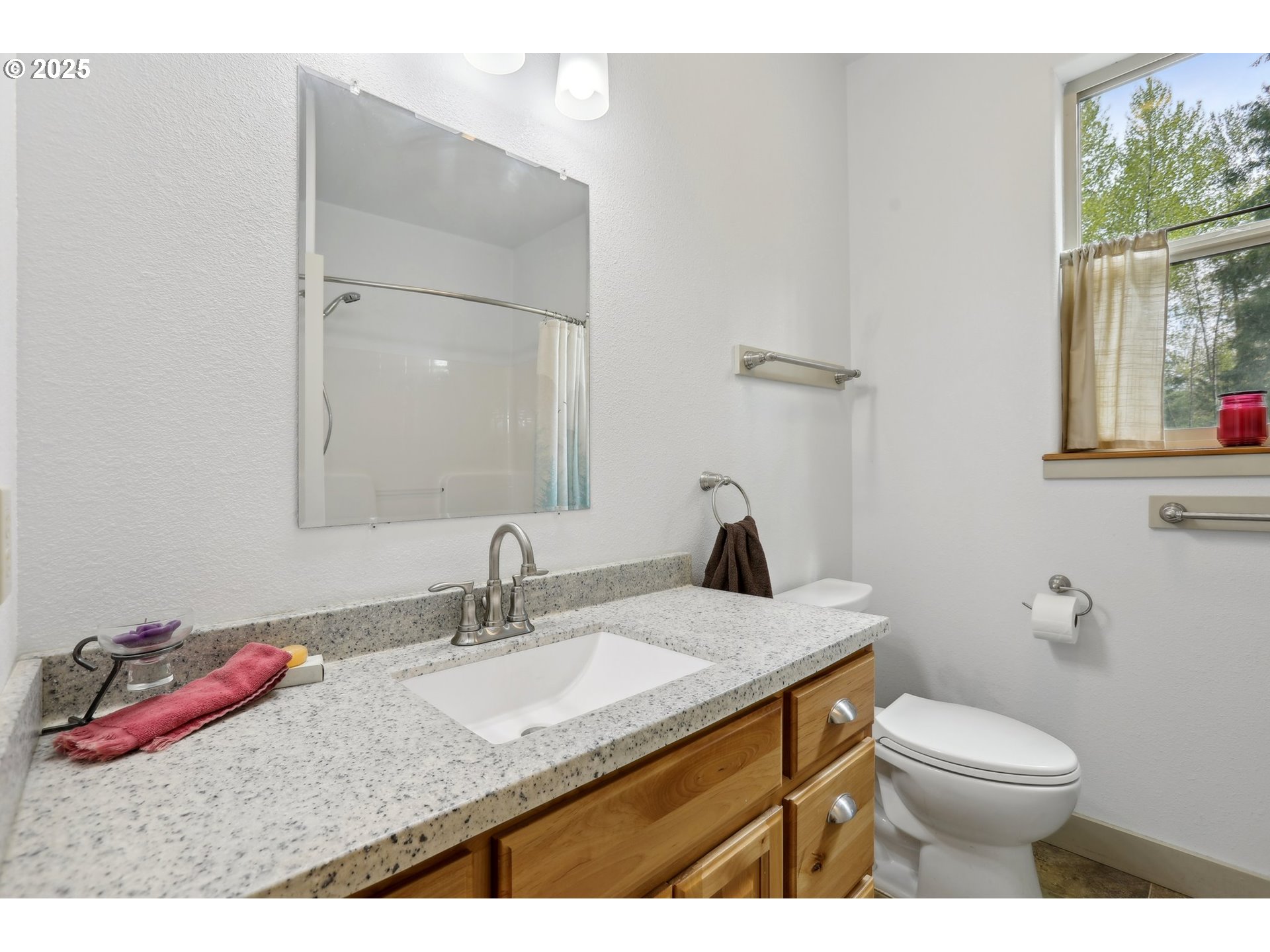 230 Riley Court Toutle, WA 98649 - Photo 34 of 48 a bathroom with a granite countertop sink and a mirror
