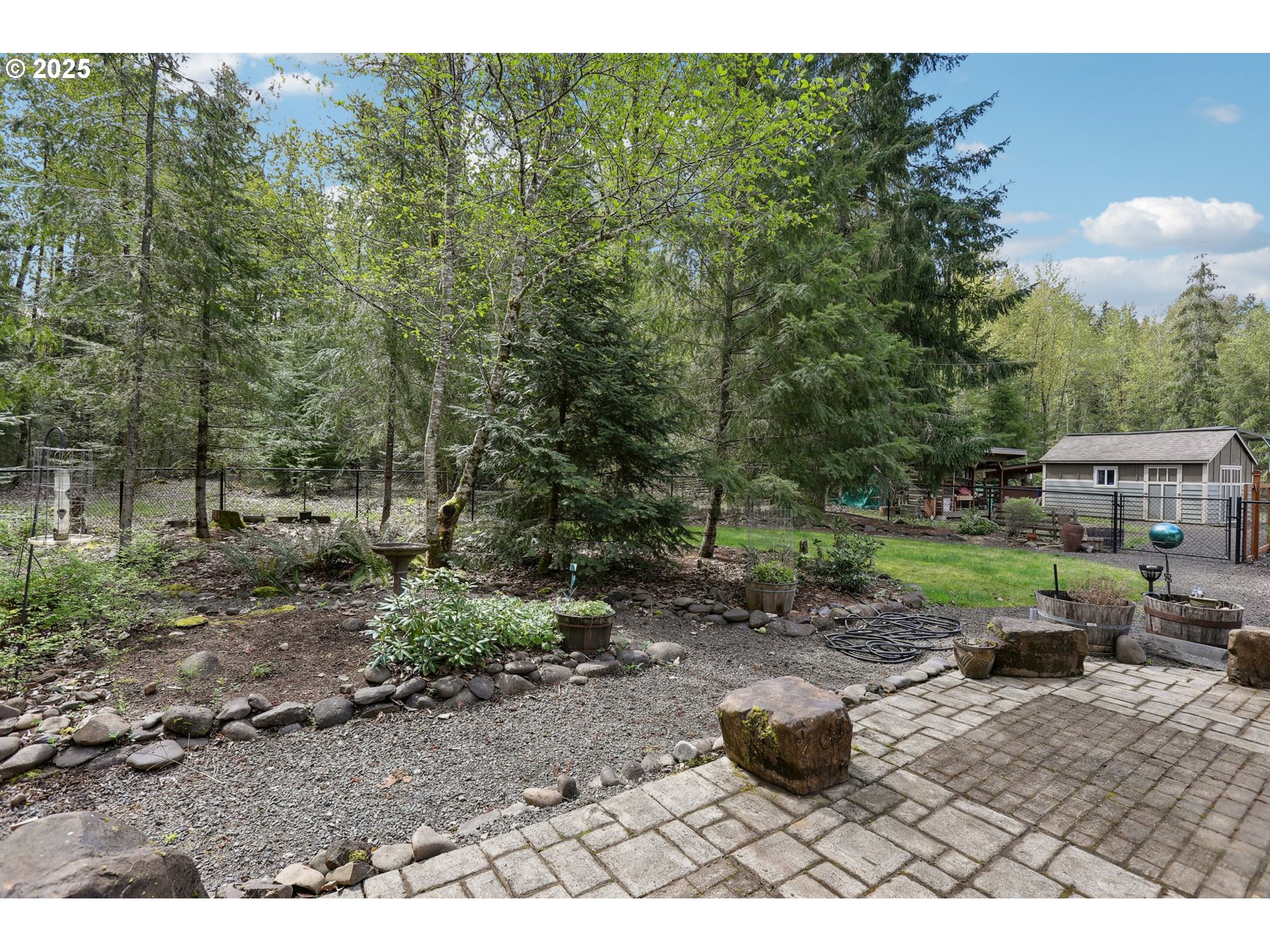 230 Riley Court Toutle, WA 98649 - Photo 41 of 48 a view of a backyard with table and chairs potted plants and large trees