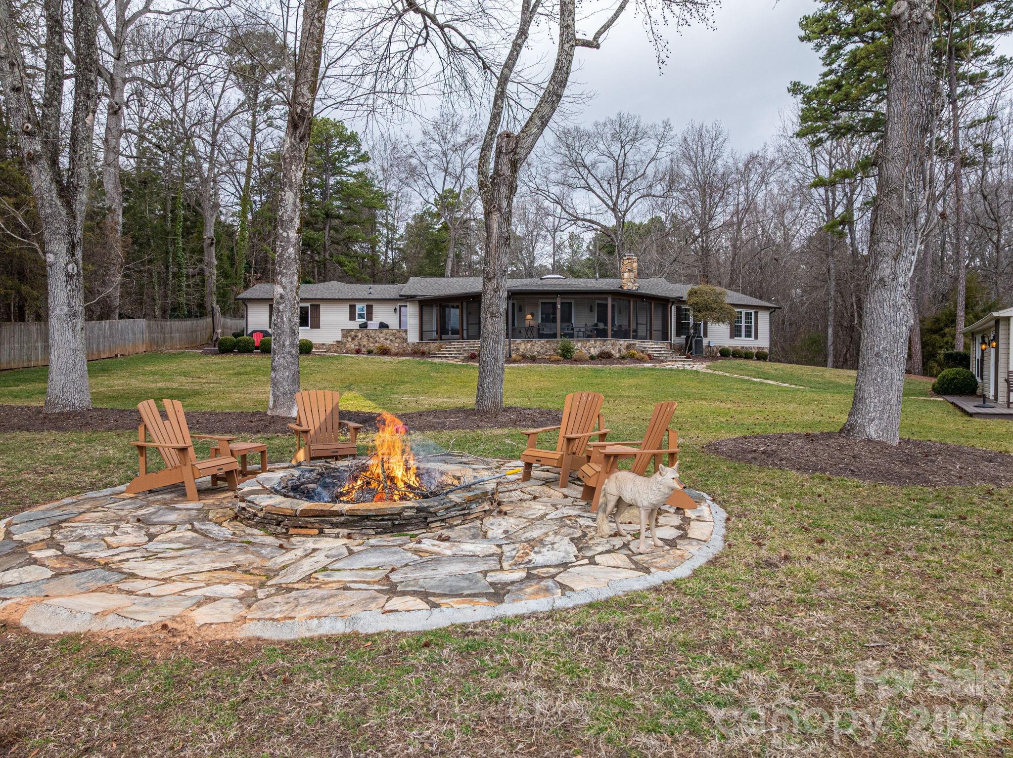 4485 River Oaks Road Lake Wylie, SC 29710 - Photo 6 of 16 a view of a house with backyard sitting area and garden