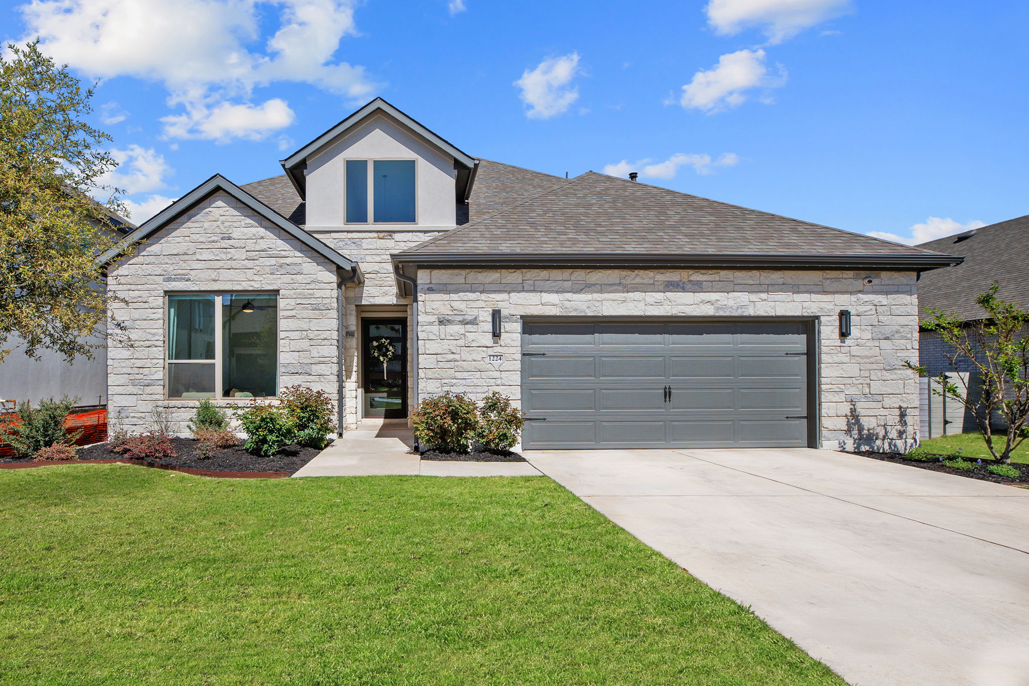 1224 River Trace Georgetown, TX 78628 - Photo 37 of 39 a front view of a house with a yard and garage