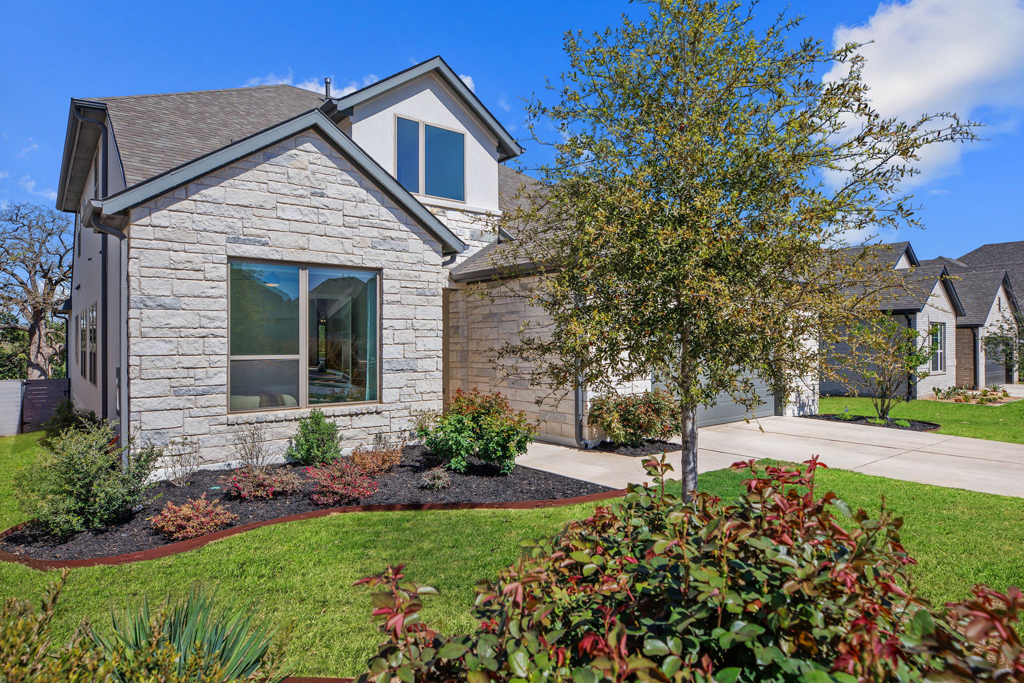 1224 River Trace Georgetown, TX 78628 - Photo 38 of 39 a front view of a house with a yard and potted plants