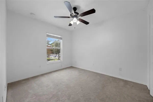 a view of a livingroom with a ceiling fan and window