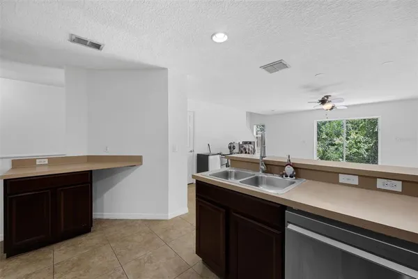 a kitchen with stainless steel appliances a refrigerator stove microwave and cabinets