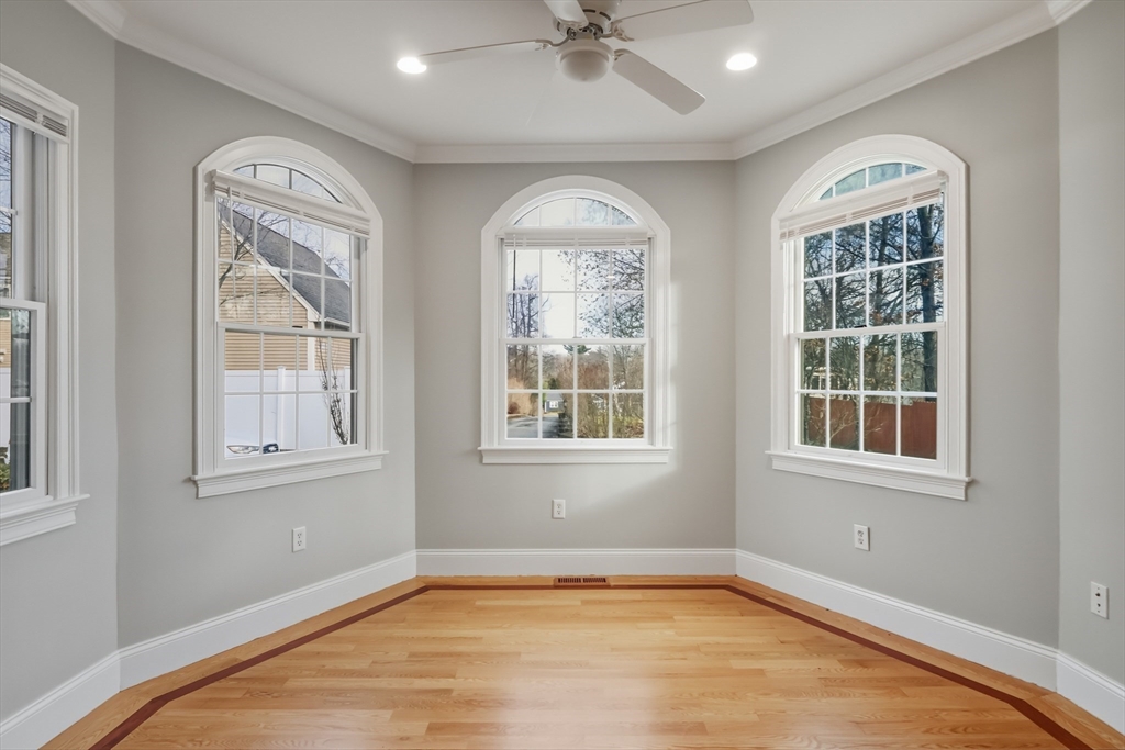 1327 Liberty Street, Unit 2 Braintree, MA 02184 - Photo 4 of 20 an empty room with wooden floor fan and windows